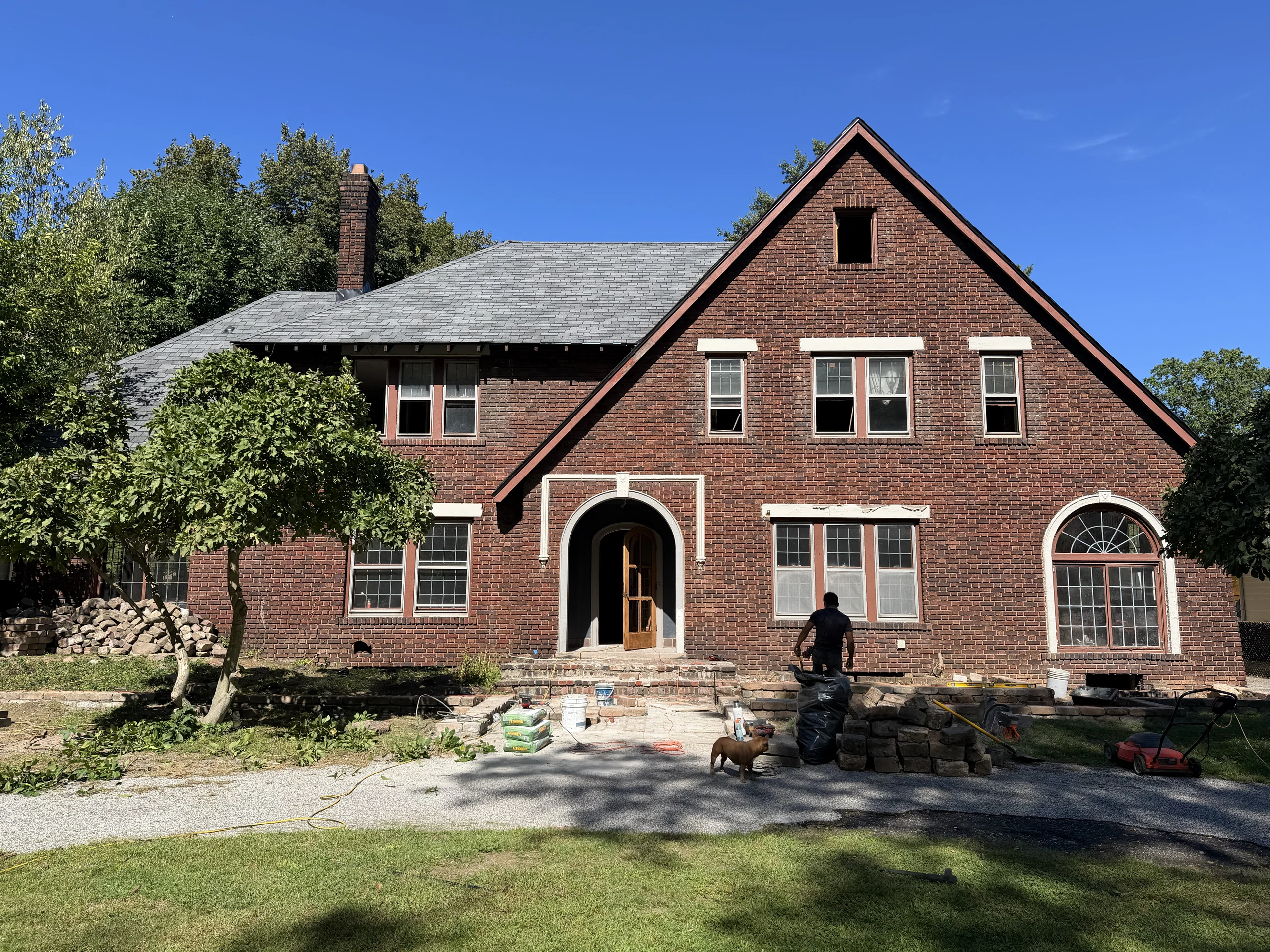 Lake Avenue exterior during renovation, with brick, arched windows and stonework in progress.
